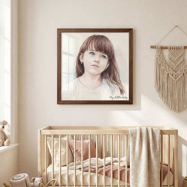 A framed portrait print of a young girl with brown hair hangs on a beige wall above a light wood crib in a softly styled nursery. The print has a dark brown frame, and the room includes a macrame wall hanging, bedding, and a small stuffed toy. - Image 2