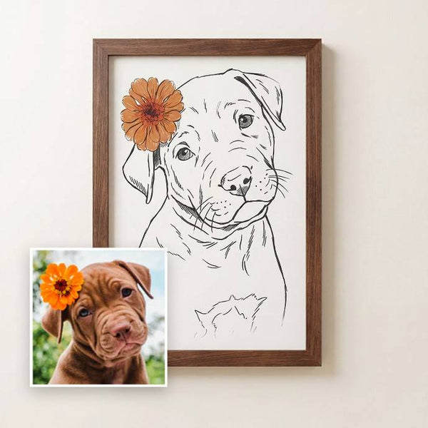 A framed custom pet portrait print featuring a black line art sketch of a puppy with an orange flower accent, shown next to a small reference photo of a brown puppy on a light beige wall. - Image 1