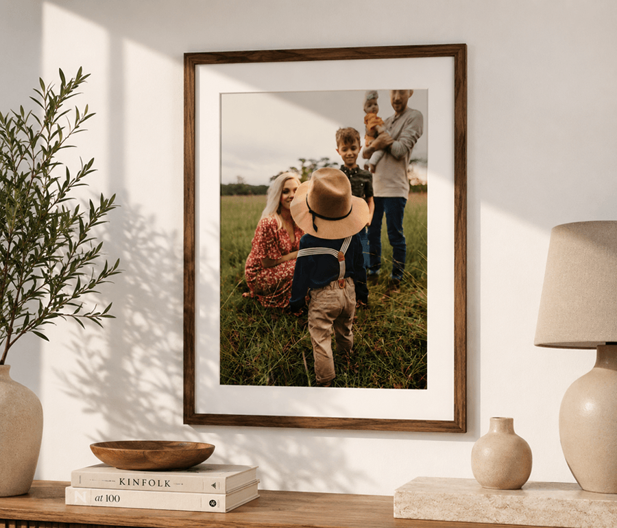 Framed family photo on a wall with decor items below