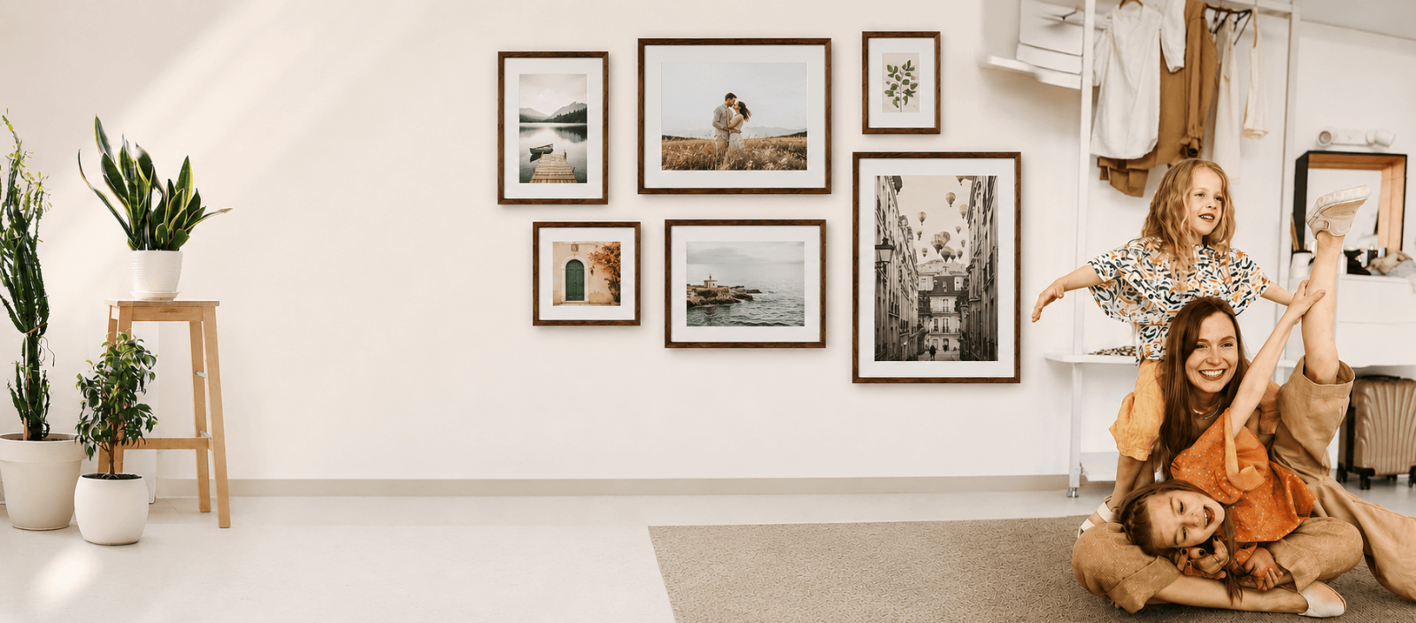 Family enjoying time together beneath a gallery wall of wood picture frames displaying personalized photos.