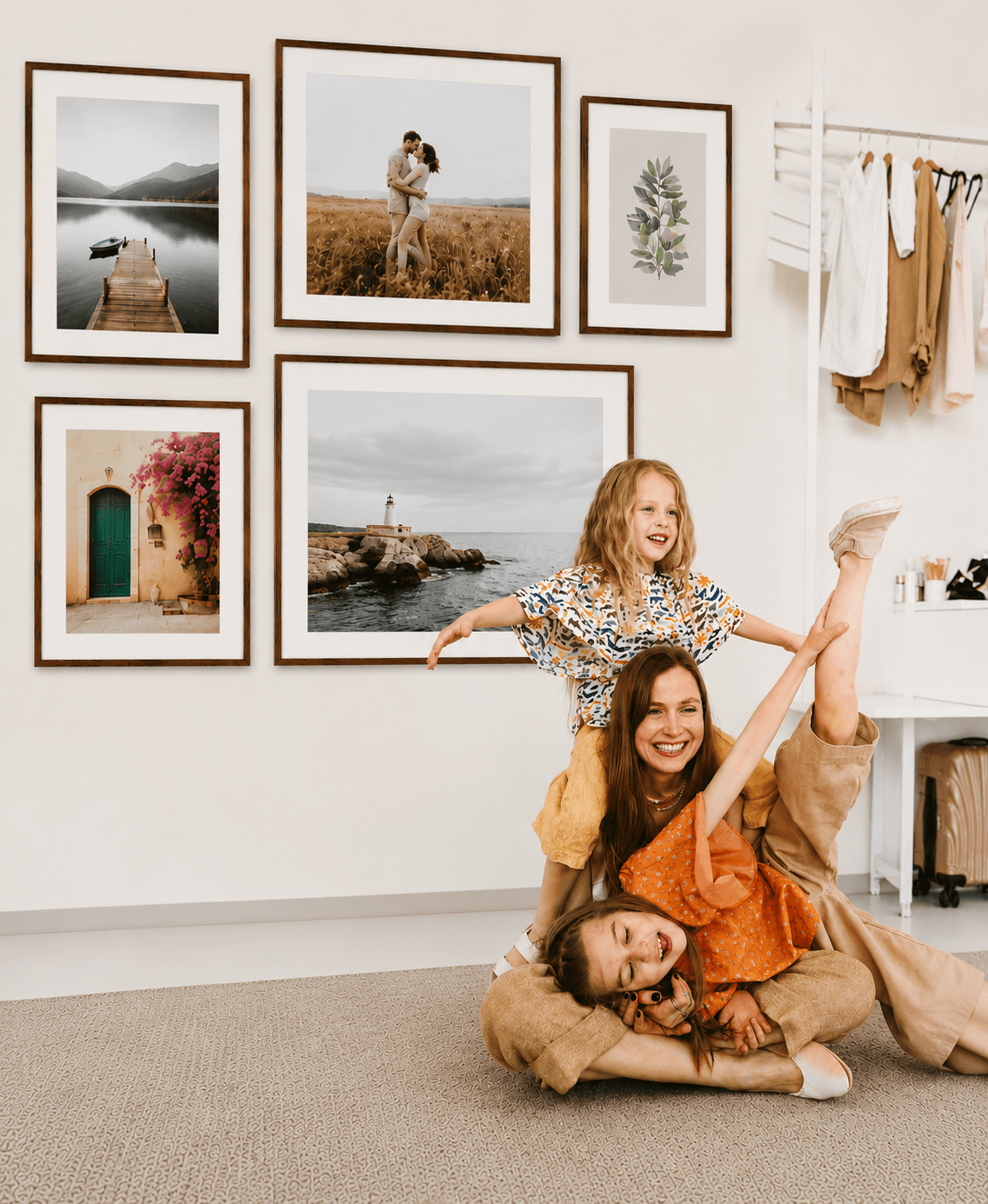 Family enjoying time together beneath a gallery wall of wood picture frames displaying personalized photos.